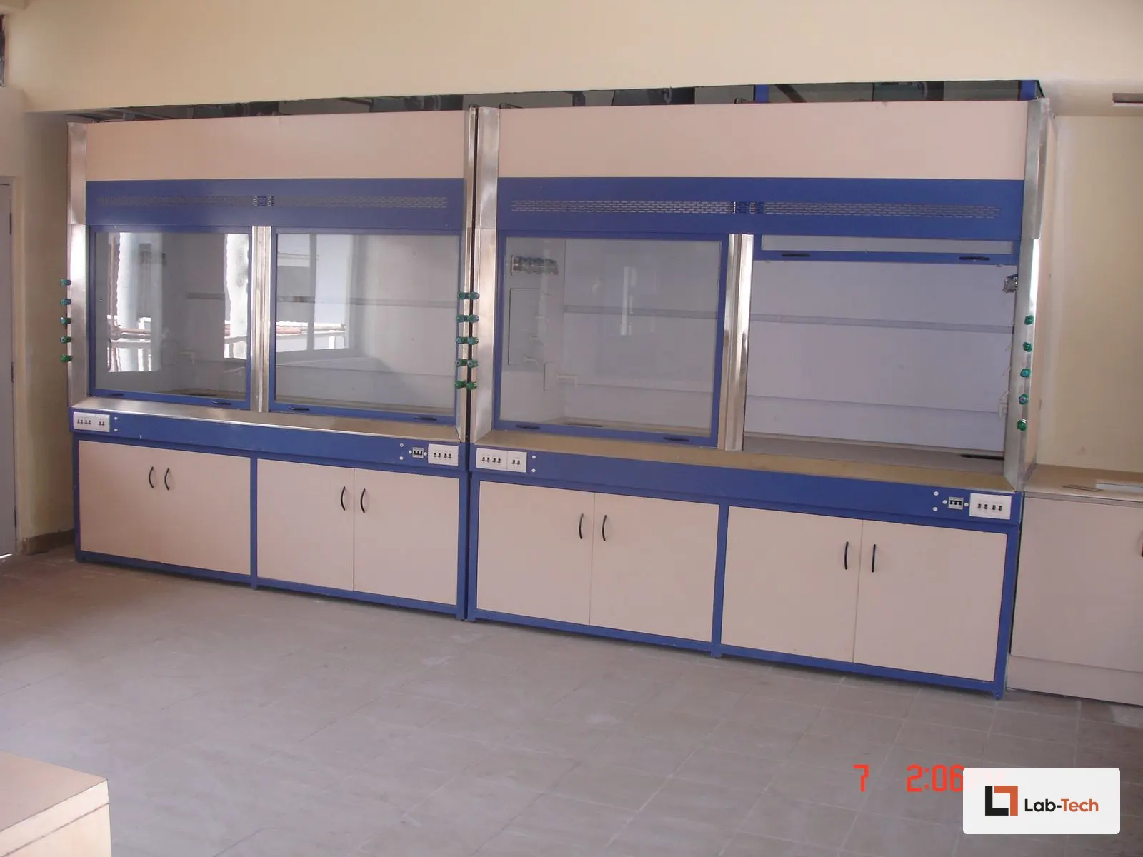Twin Lab-Tech fume hoods with service fixtures and storage, installed side by side.